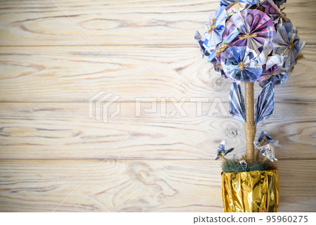 Decorative tree made from EURO banknotes in golden flowerpot. Ba 95960275
