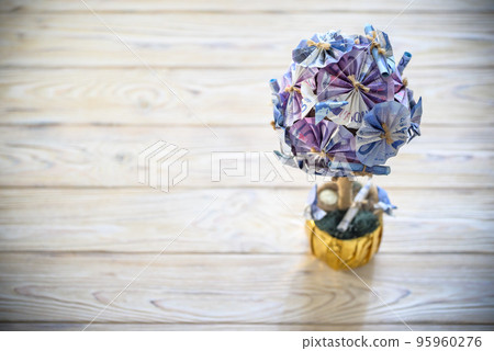 Decorative tree made from EURO banknotes in golden flowerpot. Bank deposit grow savings concept Decorative tree made from EURO banknotes in golden flowerpot. Bank deposit grow savings concept 95960276