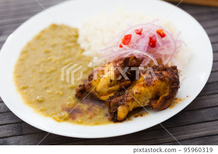 Peruvian dish. chicken wings with pea puree, rice and pickled onions Peruvian dish. chicken wings with pea puree, rice and pickled onions 95960319