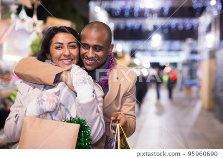 Husband and wife with gifts walk in the new year fair Husband and wife with gifts walk in the new year fair 95960690