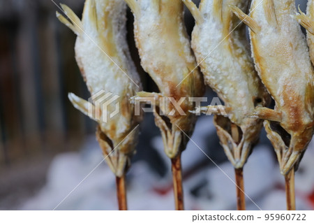 Salt-grilled sweetfish skewers sold at food stalls Salt-grilled sweetfish skewers sold at food stalls 95960722