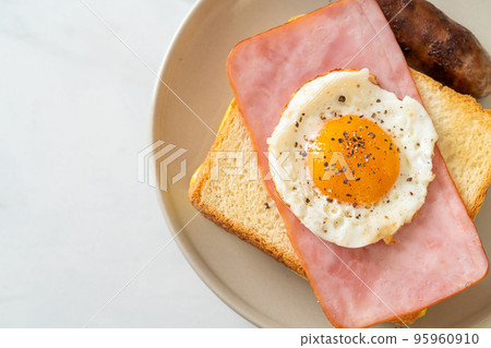 bread toasted cheese topped ham and fried egg with pork sausage 95960910