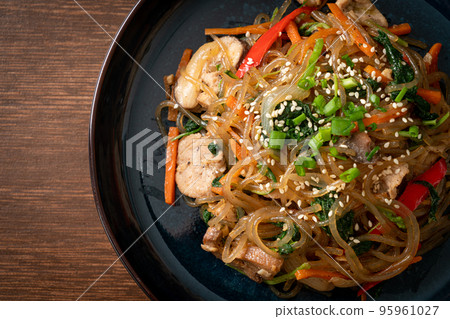 japchae or stir-fried Korean vermicelli noodles with vegetables and pork topped with white sesame 95961027