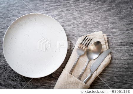 empty plate or dish with knife, fork and spoon empty plate or dish with knife, fork and spoon 95961328