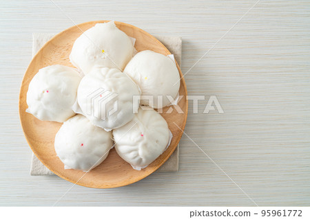 stuffed steamed bun on wood plate stuffed steamed bun on wood plate 95961772