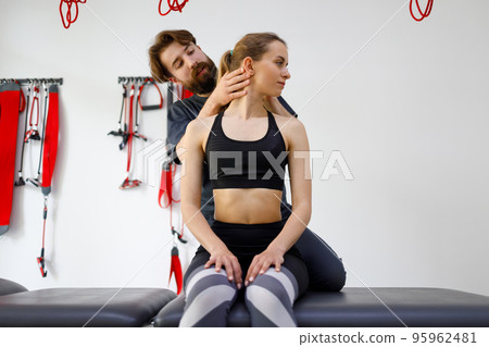 Young woman on preventive examination of doctor chiropractor or .orthopedist on spine diagnostic. Manual therapist turning patient's neck to make a diagnosis and find problem Young woman on preventive examination of doctor chiropractor or .orthopedist on spine diagnostic. Manual therapist turning patient's neck to make a diagnosis and find problem 95962481