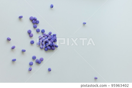 Scattered blue pills on a white background. Dental plaque detection tool Scattered blue pills on a white background. Dental plaque detection tool 95963402