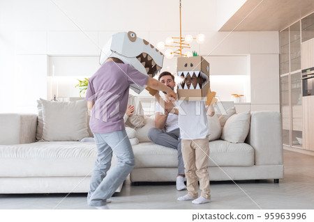 Family playing dinosaurs at home 95963996