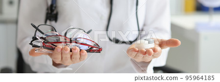 Female doctor making choice between contact lenses and glasses 95964185