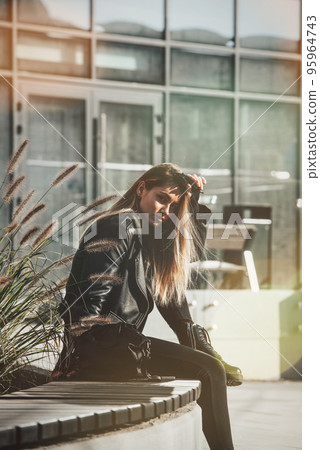 Urban woman sitting on a bench of a park and breathing deep fresh air 95964743