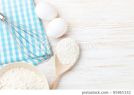 Baking ingredients on white wooden background Baking ingredients on white wooden background 95965332