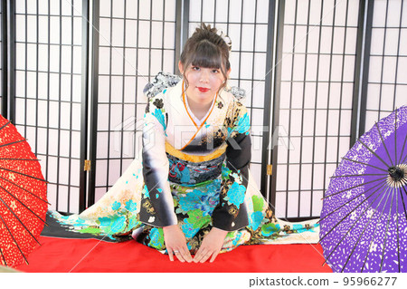 An adult woman wearing a kimono with a turquoise pattern on a white background, kimono studio photography, coming-of-age ceremony 95966277