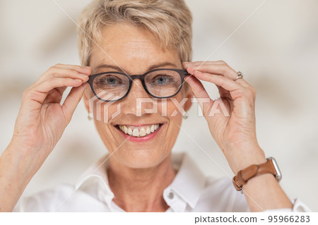 Mature woman, face and vision glasses in fashion or style eye care for healthcare insurance, medical wellness or glaucoma support. Smile portrait, happy person and optometry prescription eyes lenses Mature woman, face and vision glasses in fashion or style eye care for healthcare insurance, medical wellness or glaucoma support. Smile portrait, happy person and optometry prescription eyes lenses 95966283