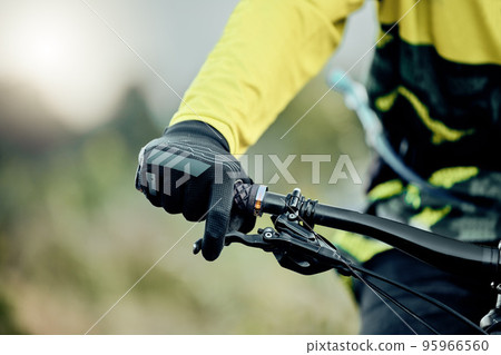 Cyclist hand, bike handlebar brake and safety on tour, race or ride for fitness, health and wellness in nature. Bicycle handbrake, adventure mountain bike and control speed while outdoor for cycling Cyclist hand, bike handlebar brake and safety on tour, race or ride for fitness, health and wellness in nature. Bicycle handbrake, adventure mountain bike and control speed while outdoor for cycling 95966560