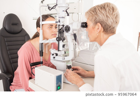 Vision, eye and test with optometrist for glasses, eyecare and eyes wellness in medical office. Ophthalmologist, ophthalmology and healthcare optician exam for prescription eyewear and health Vision, eye and test with optometrist for glasses, eyecare and eyes wellness in medical office. Ophthalmologist, ophthalmology and healthcare optician exam for prescription eyewear and health 95967064