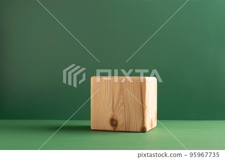 Abstract empty podium wooden geometric shapes, green background. Template for demonstrating products 95967735
