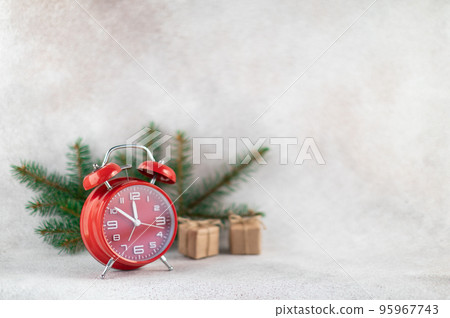 New Year clock with fir branch holiday card on light winter background New Year clock with fir branch holiday card on light winter background 95967743