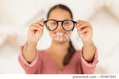 Vision, eyesight and woman with glasses in hands for eye test, holding spectacles in blurred background. Healthcare, medical insurance and eyes, girl in blur with prescription lens in spectacle frame 95967891