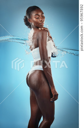 Beauty, water splash and skincare, black woman in underwear, blue background in studio. Fashion, health and fresh clean water for woman with healthy mindset, lifestyle body positivity in South Africa 95967892