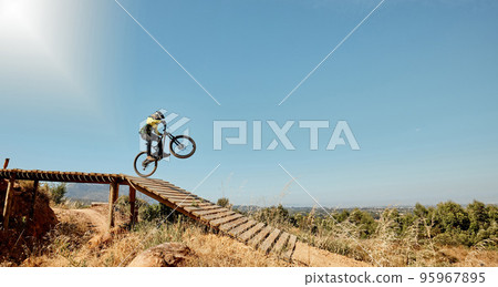 Sports, mountain bike and ramp jump in nature, cycling .and outdoors stunt performance. Fitness, workout and exercise of bmx athlete and racer on bicycle training for competition, race or contest. 95967895