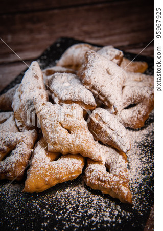 TRADITIONAL WONDERS OF SOUTH-WESTERN FRANCE, SPRINKLED WITH ICING SUGAR AND FLAVOURED WITH RUM AND TRADITIONAL WONDERS OF SOUTH-WESTERN FRANCE, SPRINKLED WITH ICING SUGAR AND FLAVOURED WITH RUM AND 95967925