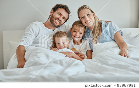 Family, children and bed with a girl, sister and parents in the bedroom of a home to relax together in the morning. Portrait, love and smile with a happy mother, father and daughter siblings bonding Family, children and bed with a girl, sister and parents in the bedroom of a home to relax together in the morning. Portrait, love and smile with a happy mother, father and daughter siblings bonding 95967981