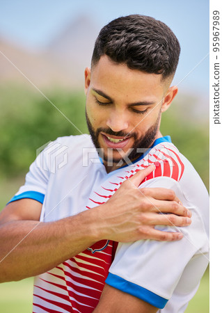 Sports, football and man with shoulder pain, injury or training accident from competition, exercise or fitness workout. Game emergency, muscle problem and athlete soccer player hurt on soccer field 95967989