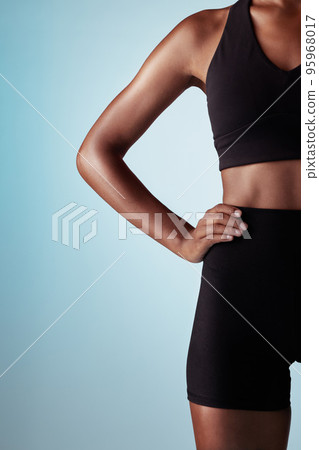Fitness, body and black woman in studio with workout fashion, skincare and wellness on blue mock up for advertising or marketing space. Sports, runner or athlete zoom in training clothes and mockup 95968017