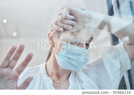 Senior woman, covid face mask or depression in house quarantine or home lockdown safety. Covid 19, window or sick retirement elderly with stress, anxiety or mental health in government law compliance 95968158
