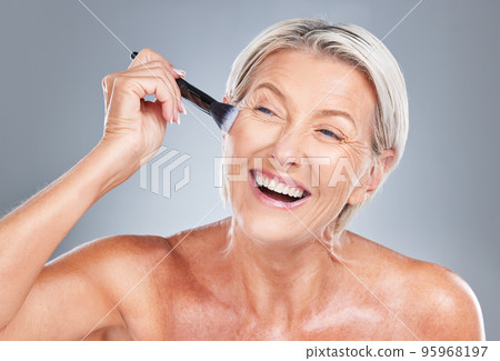 Happy, senior woman and makeup brush in studio for beauty, skincare and wrinkles treatment on a grey background. Face, cheek and product by elderly model happy, excited and smiling about cosmetics Happy, senior woman and makeup brush in studio for beauty, skincare and wrinkles treatment on a grey background. Face, cheek and product by elderly model happy, excited and smiling about cosmetics 95968197
