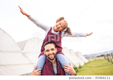 Farm, play and portrait of father, child or happy family having fun, bond and enjoy quality time together on agriculture grass field. Love, sustainability farming and eco farmer walking with kid girl Farm, play and portrait of father, child or happy family having fun, bond and enjoy quality time together on agriculture grass field. Love, sustainability farming and eco farmer walking with kid girl 95968212