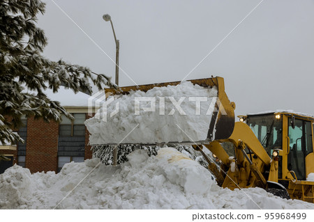 Snow removal with truck to clear parking lot and road of snow Snow removal with truck to clear parking lot and road of snow 95968499