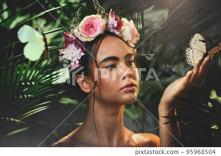Beauty, flowers and butterfly with a model woman in studio on a forest or amazon background for wellness. Nature, spring and luxury with an attractive young female posing to promote natural care Beauty, flowers and butterfly with a model woman in studio on a forest or amazon background for wellness. Nature, spring and luxury with an attractive young female posing to promote natural care 95968504
