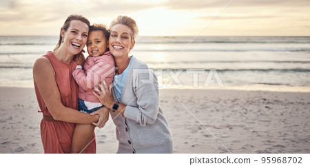 Lesbian, couple and portrait of family on beach together for travel vacation, happy and relax bonding by sea side. Happy homosexual parents, child smile and ocean sunset or relaxing in summer Lesbian, couple and portrait of family on beach together for travel vacation, happy and relax bonding by sea side. Happy homosexual parents, child smile and ocean sunset or relaxing in summer 95968702