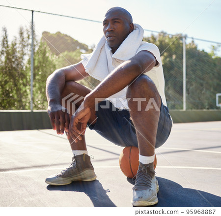 Relax, fitness and man on a basketball after workout, sitting and stop for a break at basketball court, towel and sweat. Basketball player, rest and tired after training, exercise and sports practice Relax, fitness and man on a basketball after workout, sitting and stop for a break at basketball court, towel and sweat. Basketball player, rest and tired after training, exercise and sports practice 95968887