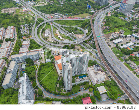 Aerial view of cars driving on highway or moterway. Overpass bridge street roads in connection network of architecture concept. Top view. Urban city, Bangkok, Thailand. Aerial view of cars driving on highway or moterway. Overpass bridge street roads in connection network of architecture concept. Top view. Urban city, Bangkok, Thailand. 95969198