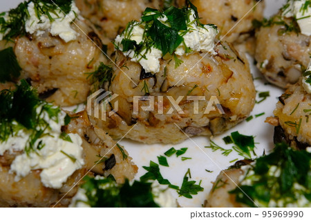 Japanese food, meat and oyster mushroom rice ball with green on top of the cheese on white plate 95969990
