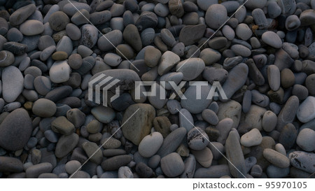 Sea stones background with small pebbles or stone in garden or in the seaside or on a beach. A close up view of rounded smooth polished pebble stones Sea stones background with small pebbles or stone in garden or in the seaside or on a beach. A close up view of rounded smooth polished pebble stones 95970105