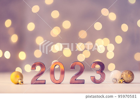 Metal numbers 2023 on a white table with bokeh lights. Happy New Year 2022 is coming concept. Metal numbers 2023 on a white table with bokeh lights. Happy New Year 2022 is coming concept. 95970581
