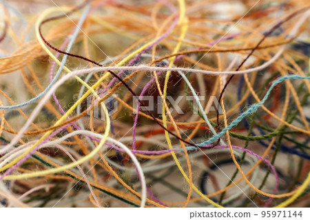 Multi-colored tangled colorful needlecraft silk thread rope. Macro shot. Abstract colors background 95971144