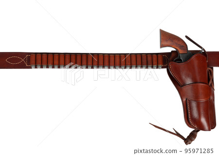 Old west weapon. Leather gun belt with ammnunitions and revolver in holster Old west weapon. Leather gun belt with ammnunitions and revolver in holster 95971285