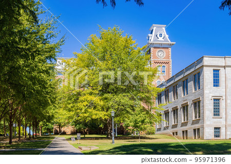 Sunny exterior view of the Old Main of University of Arkansas 95971396