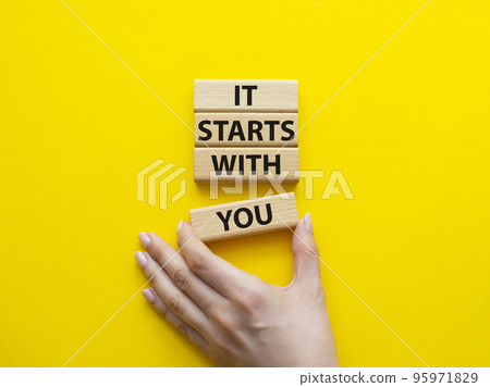 It starts with you symbol. Wooden blocks with words It starts with you. Beautiful yellow background. Businessman hand. Business and It starts with you concept. Copy space. It starts with you symbol. Wooden blocks with words It starts with you. Beautiful yellow background. Businessman hand. Business and It starts with you concept. Copy space. 95971829