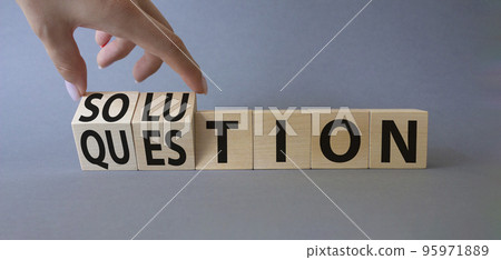 Solution and Question symbol. Hand turns a cube and changes the words Question to Solution. Beautiful grey background. Businessman hand. Business and Solution and Question concept. Copy space 95971889