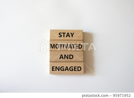 Stay Motivated and Engaged symbol. Concept words Stay Motivated and Engaged on wooden blocks. Beautiful white background. Business and Stay Motivated and Engaged concept. Copy space 95971952