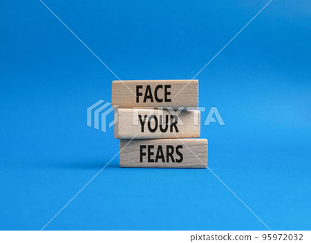 Face your Fears symbol. Wooden blocks with words Face your Fears. Beautiful blue background. Business and Face your Fears. Copy space. 95972032