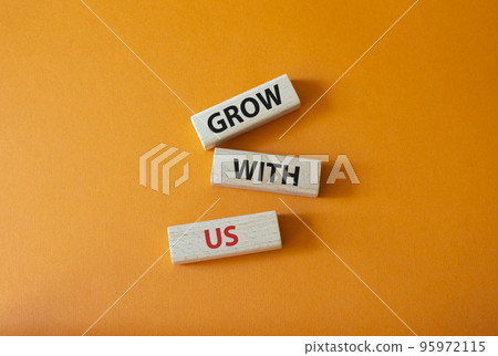 Grow with us symbol. Wooden blocks with words Grow with us. Beautiful orange background. Business and Grow with us concept. Copy space. 95972115