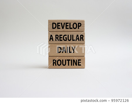 Develop a regular daily routine symbol. Concept words Develop a regular daily routine on wooden blocks. Beautiful white background. Business and Develop a regular daily routineconcept. Copy space. 95972126