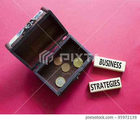 Business strategies symbol. Concept words Business strategies on wooden blocks with wooden box. Beautiful red background. Business and Business strategies concept. Copy space. Business strategies symbol. Concept words Business strategies on wooden blocks with wooden box. Beautiful red background. Business and Business strategies concept. Copy space. 95972139
