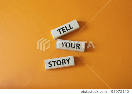 Tell your story symbol. Wooden blocks with words Tell your story. Beautiful orange background. Business and Tell your story concept. Copy space. 95972140